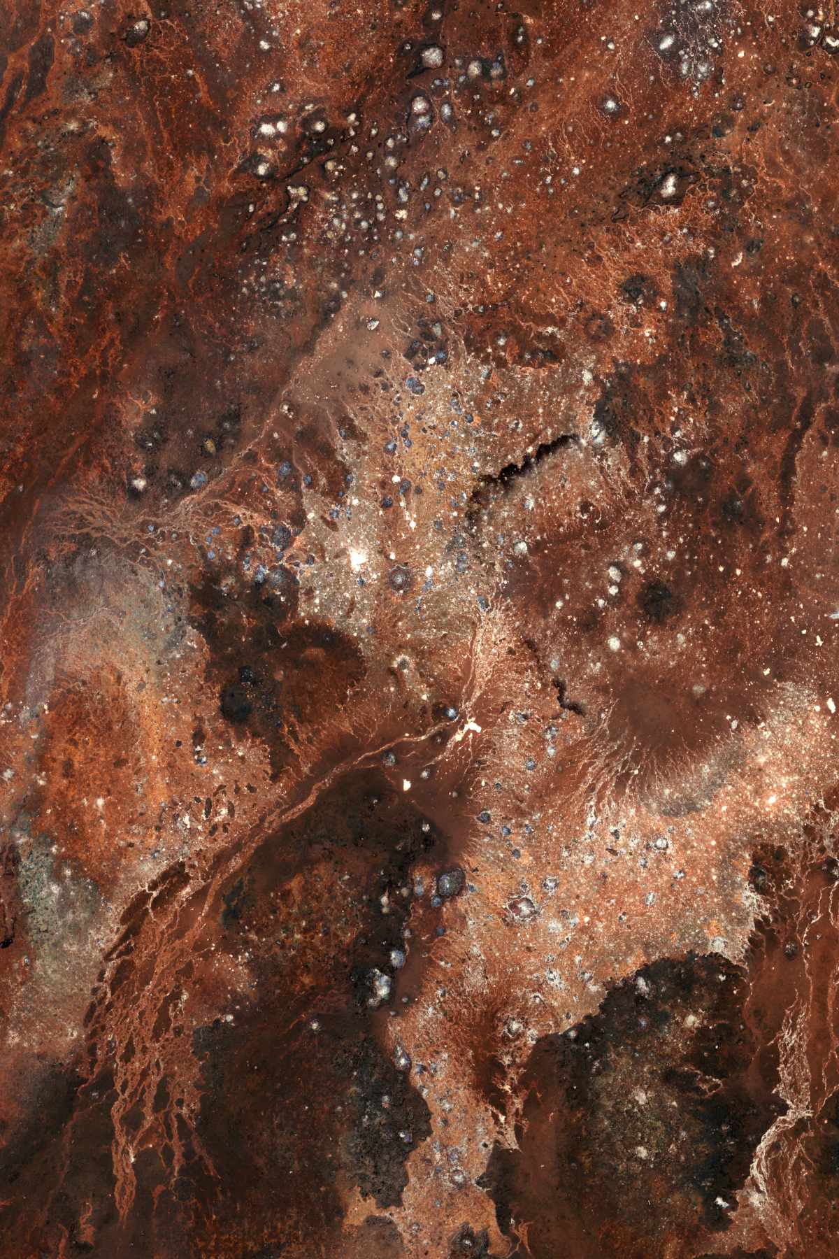 Camera-less A1 photogram using metals found in spoil tips that are prevalent in photography. This image is predominantly red with many fine details where the chemicals have interacted. These include runs and rivulets.