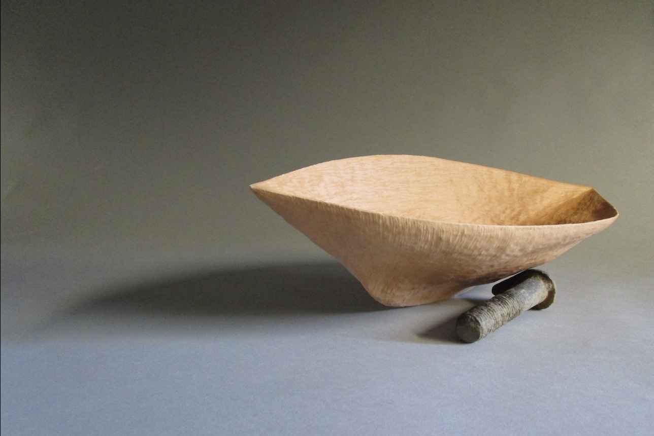 One terracotta vessel with pointed keel leaning against a found bolt.