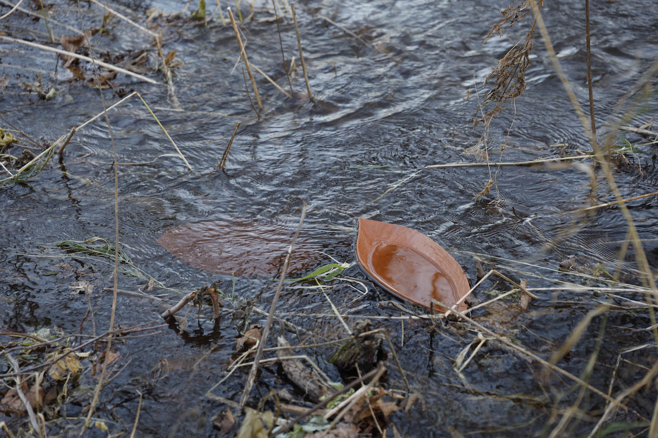 The terracotta vessels semi-submerged in the Kunda River.