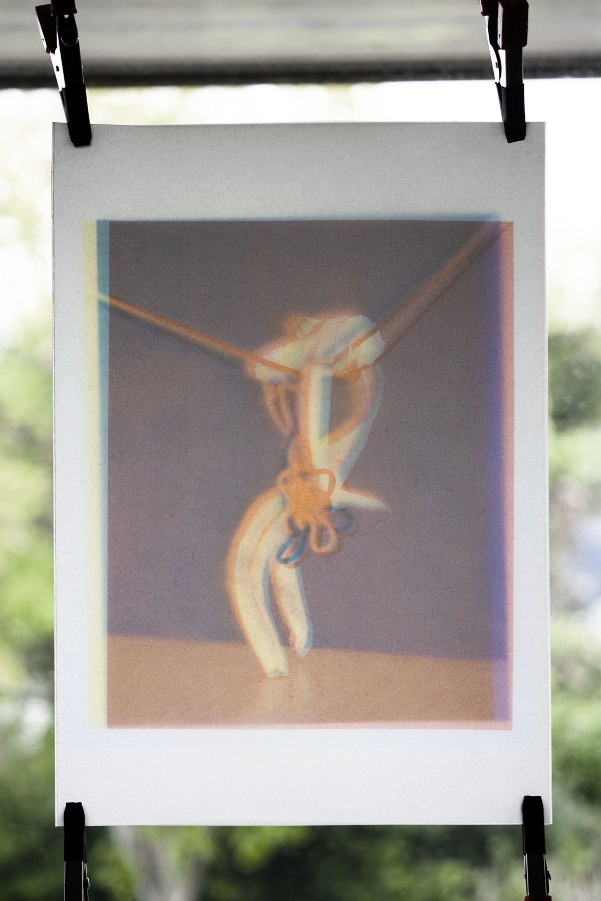 The photograph 'Xiāng Jiāo Rén' split into blue, red and yellow layers, printed onto tracing paper and folded into a zine.