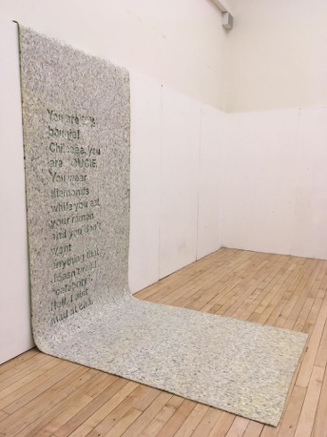 Large piece of carpet underlay with text cut out