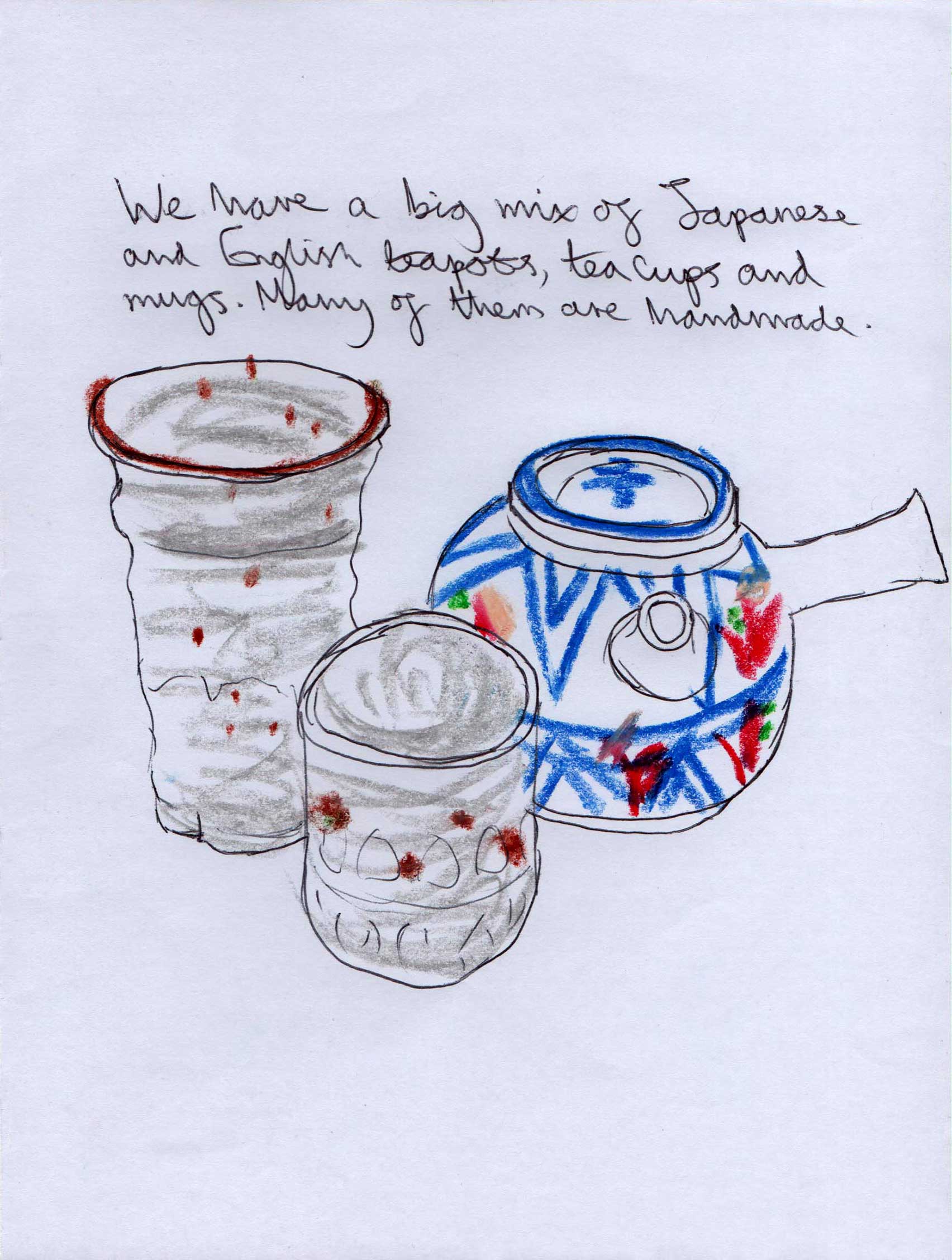 Traditional Japanese tea pot next to some traditional Japanese handmade tea cups.