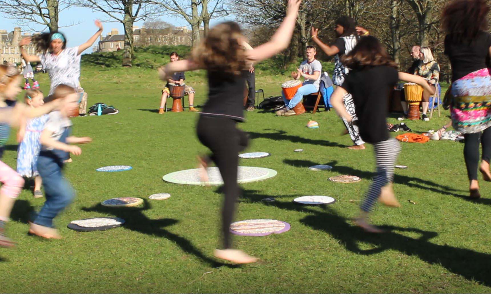 People circumambulating around the solar system in a joyful dance ritual