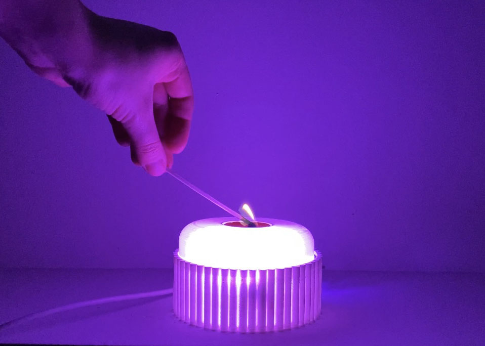 A Candle with a temperature sensor that triggers the NeoPixels to light up.