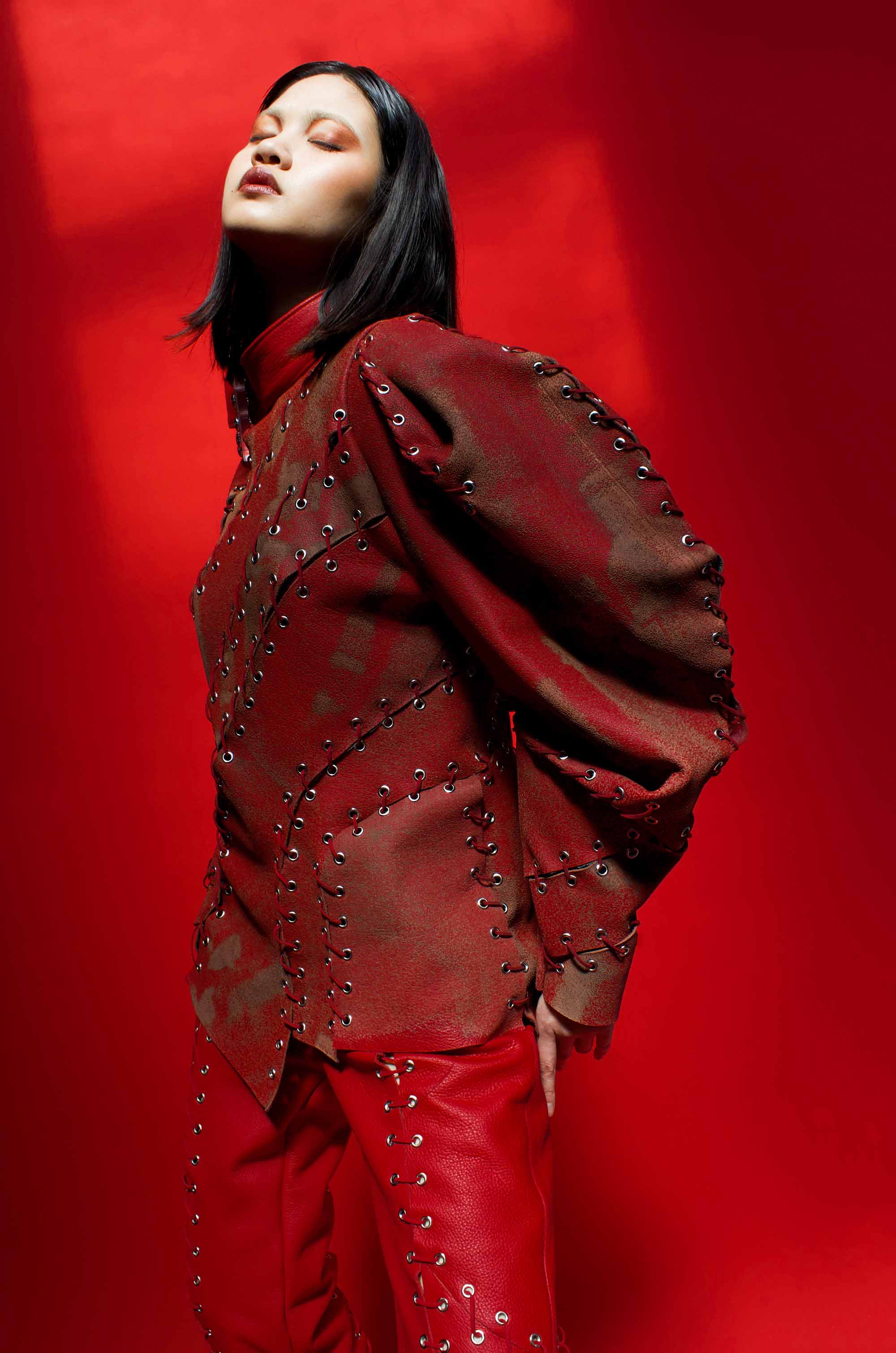 model wears laser-etched red leather jacket
