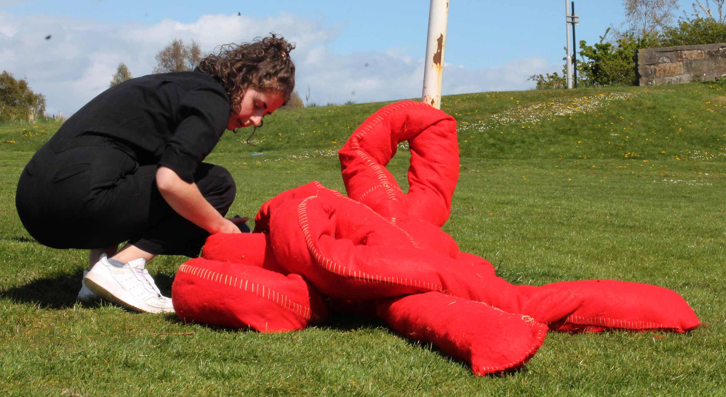 Image of Charlotte shaping red sculpture.