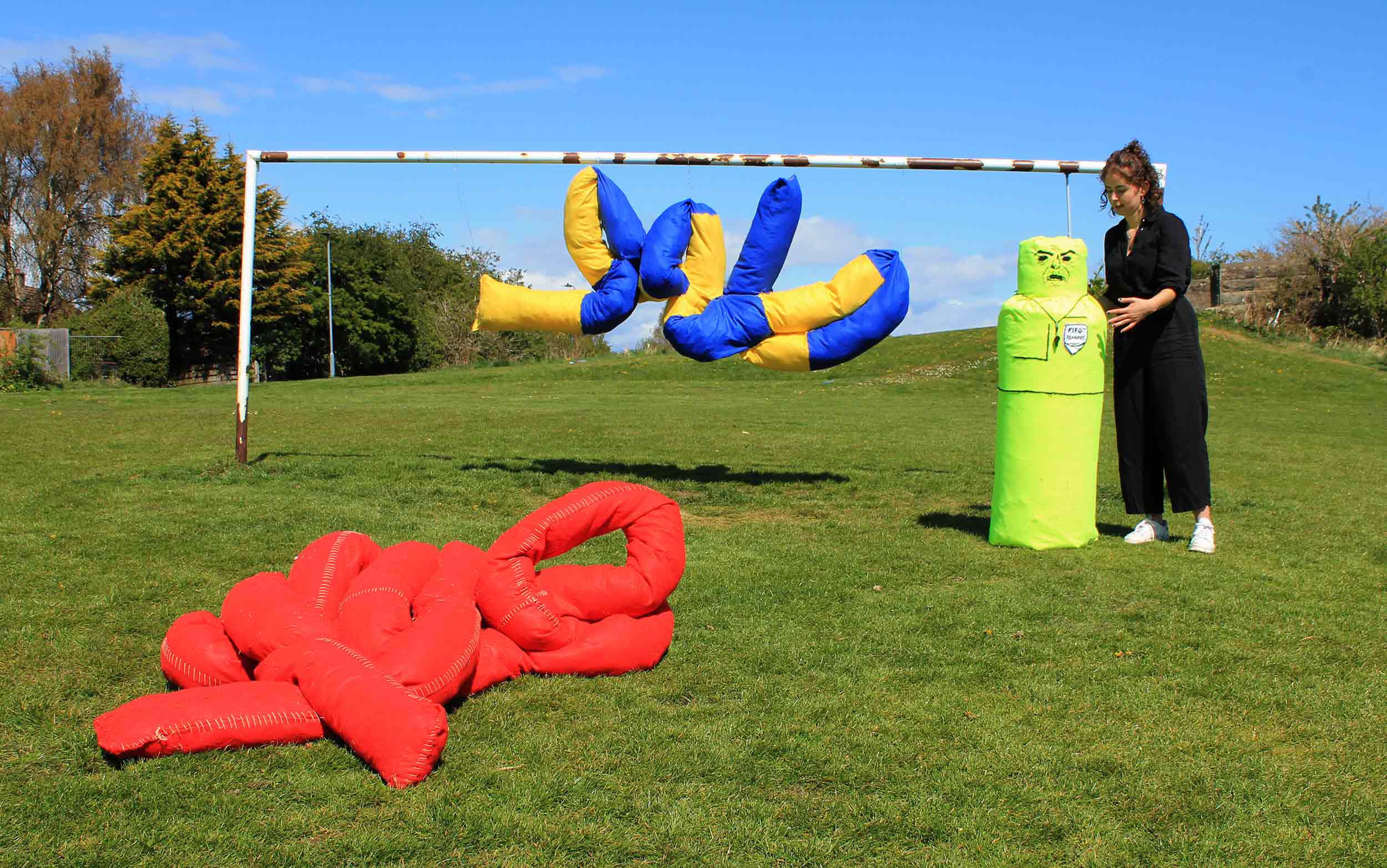 Image of Charlotte positioning the referee soft sculpture. 