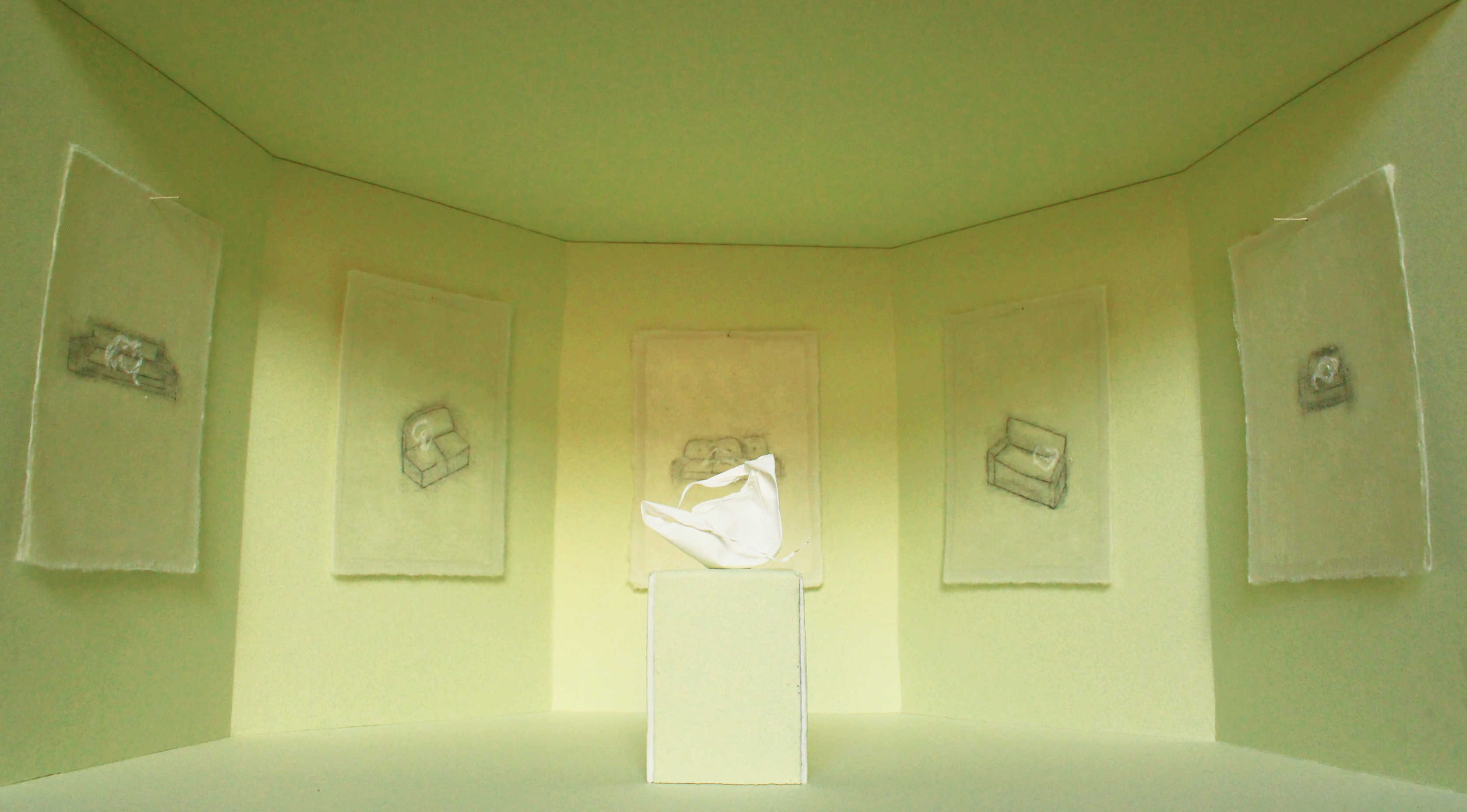 A white egg skin is sat on a green plinth, surrounded by drawings on green washi paper installed in a green room. 