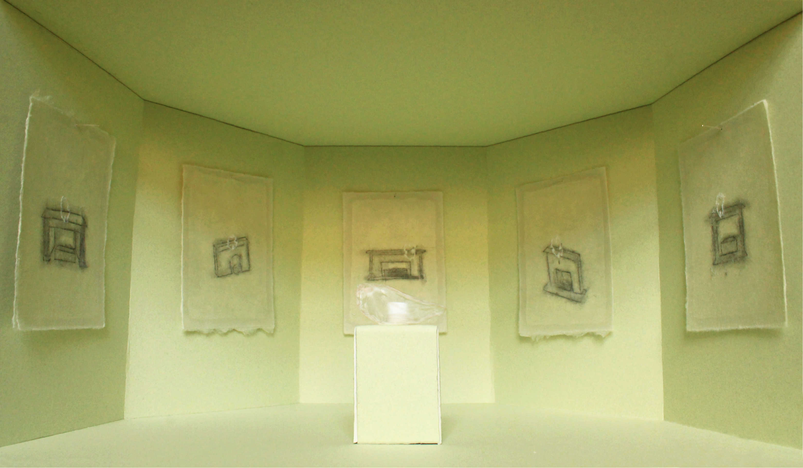 A transparent onion skin is sat on a green plinth, surrounded by drawings on green washi paper installed in a green room. 