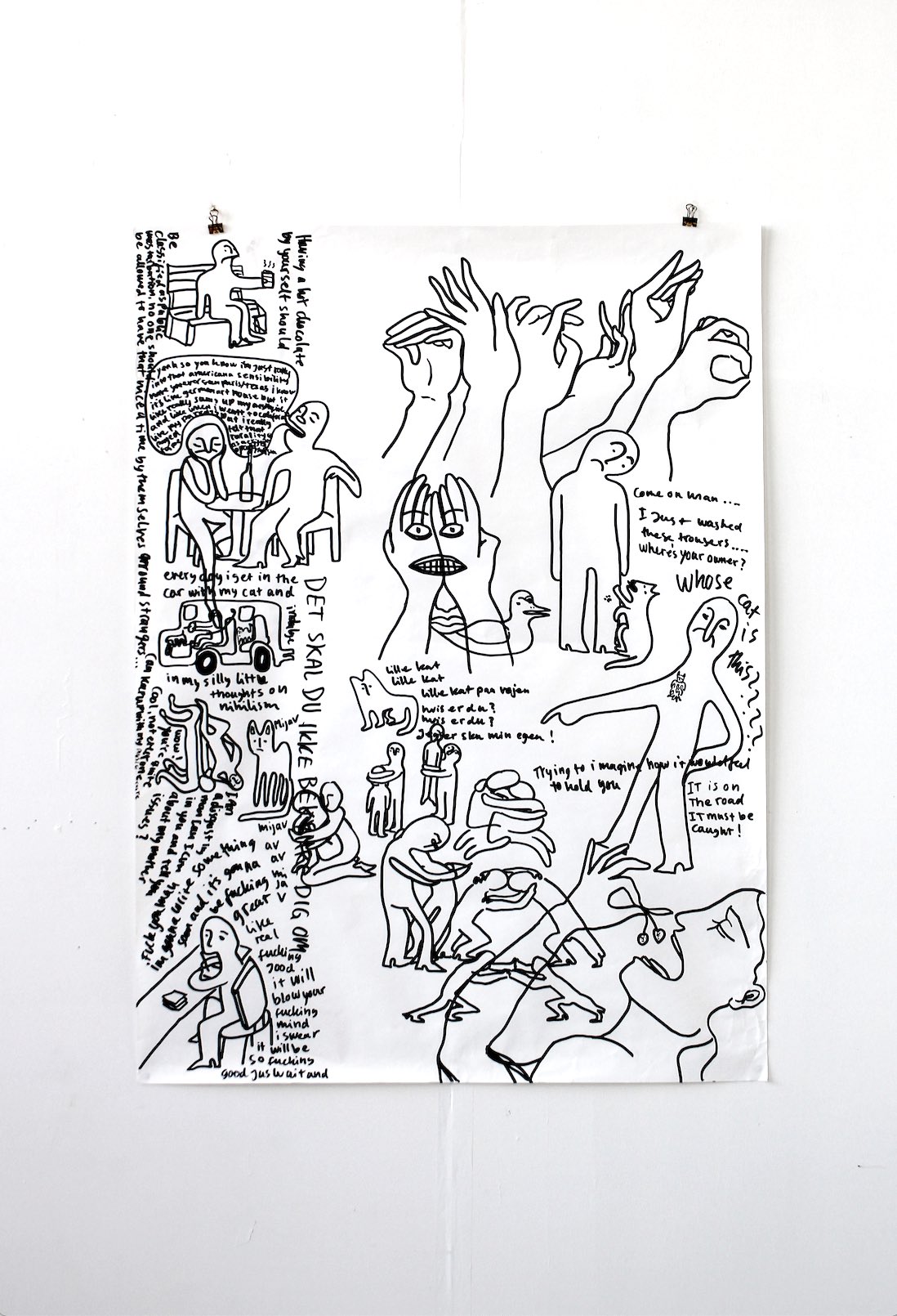 large ink drawing hung on wall showing a mix of small narratives, hands, little stories written in a panel on the side