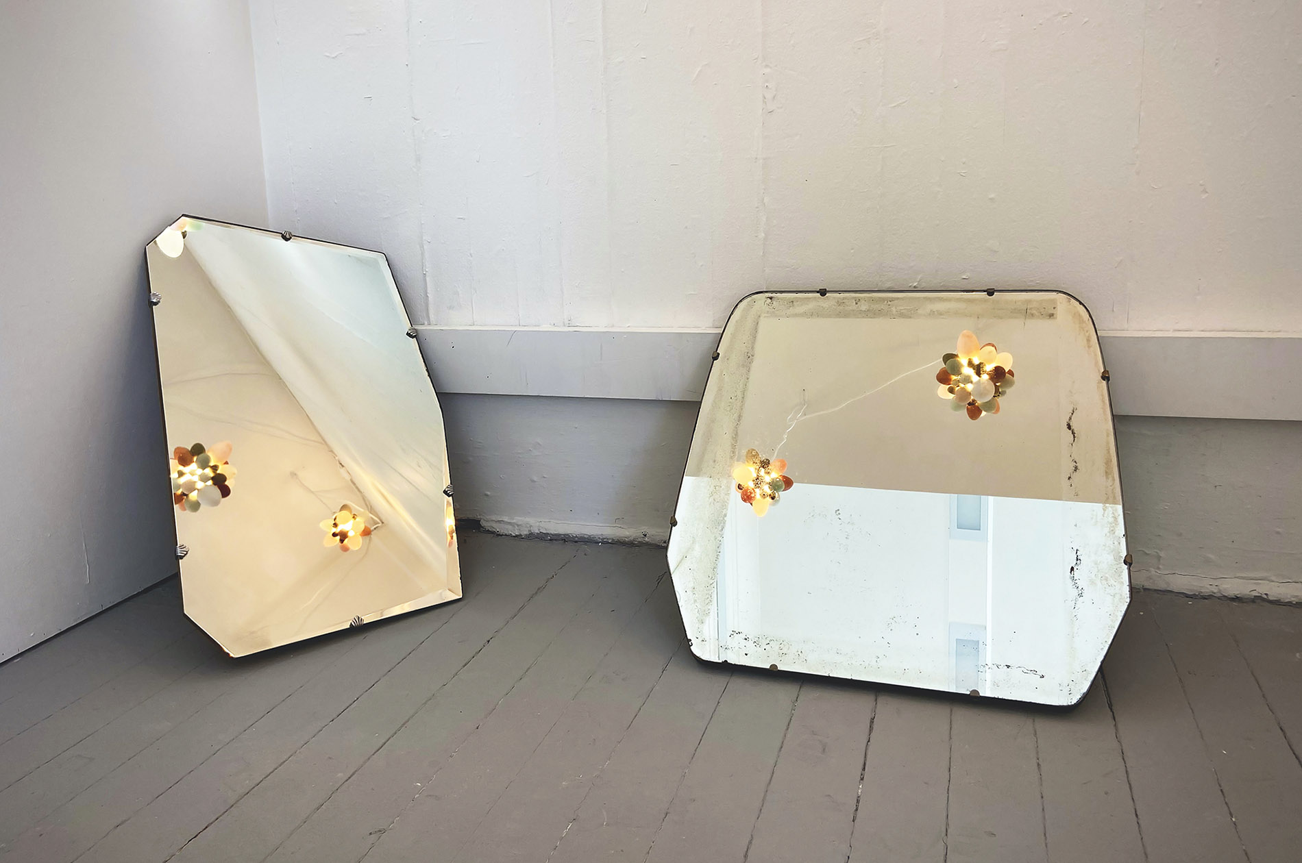 Suspended Illuminated Eggshell clusters reflected in antique mirrors