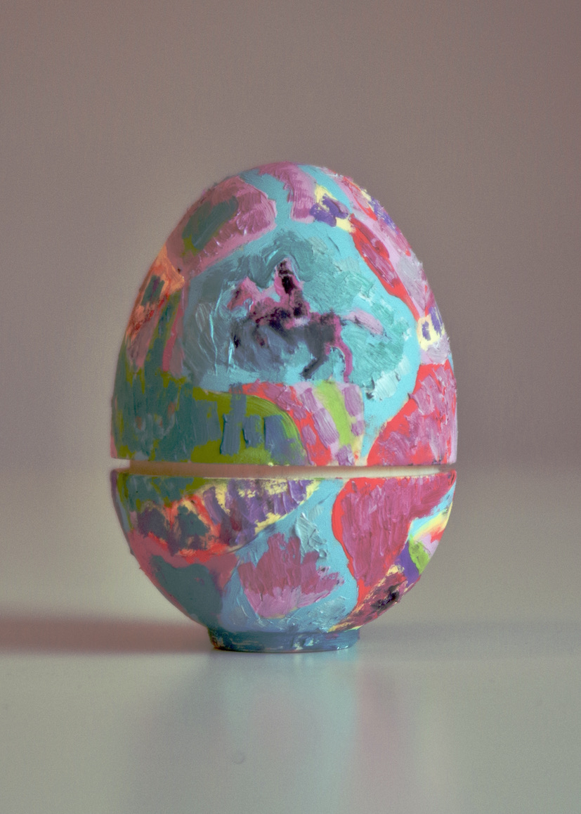 Colourful painted wooden nesting egg with an image of a horse and rider on the surface.