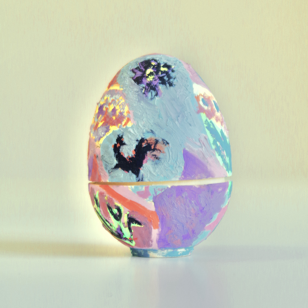 Colourful painted wooden nesting egg