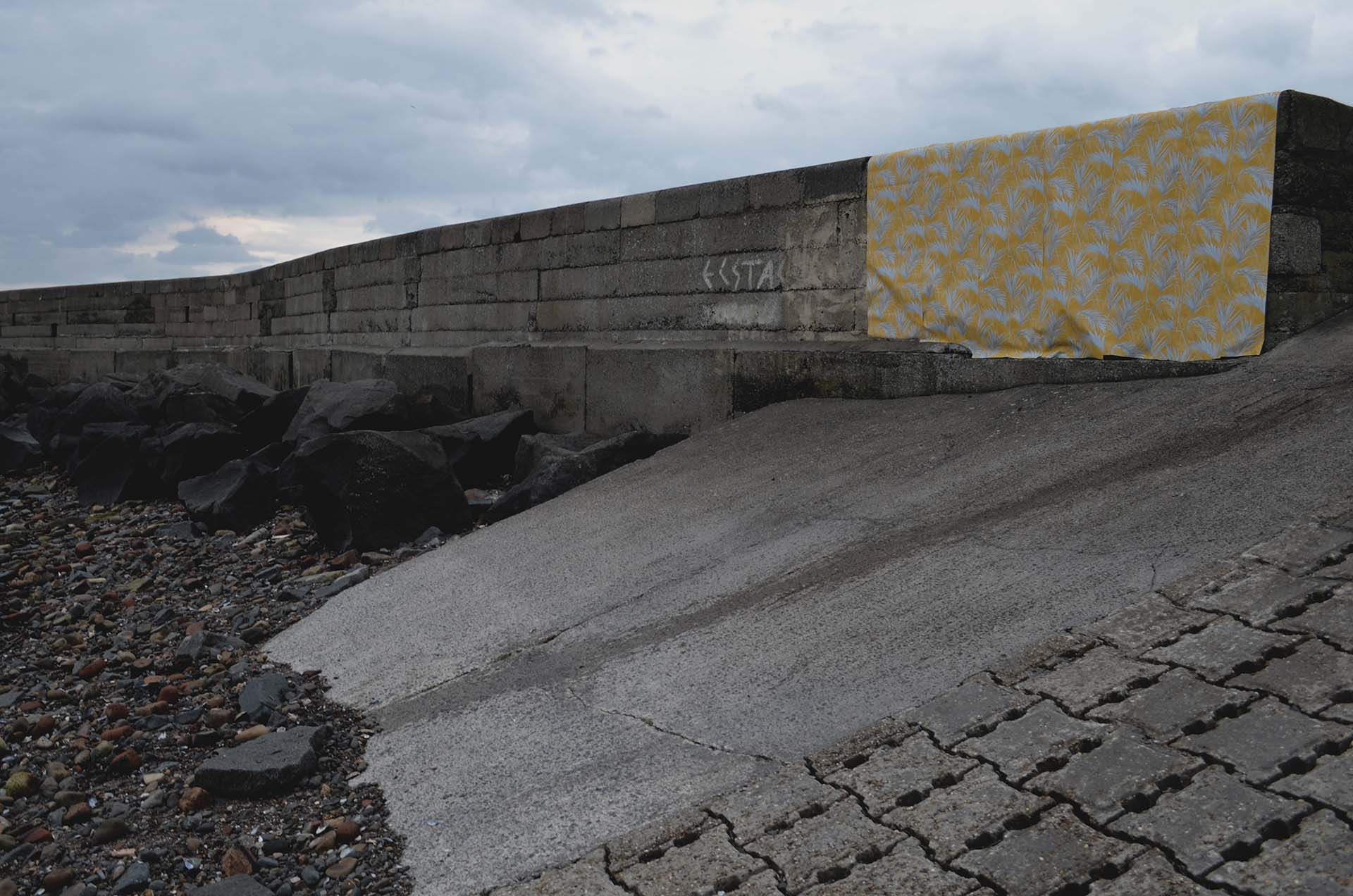 section of outdoor beach wall covered in patterned wallpaper