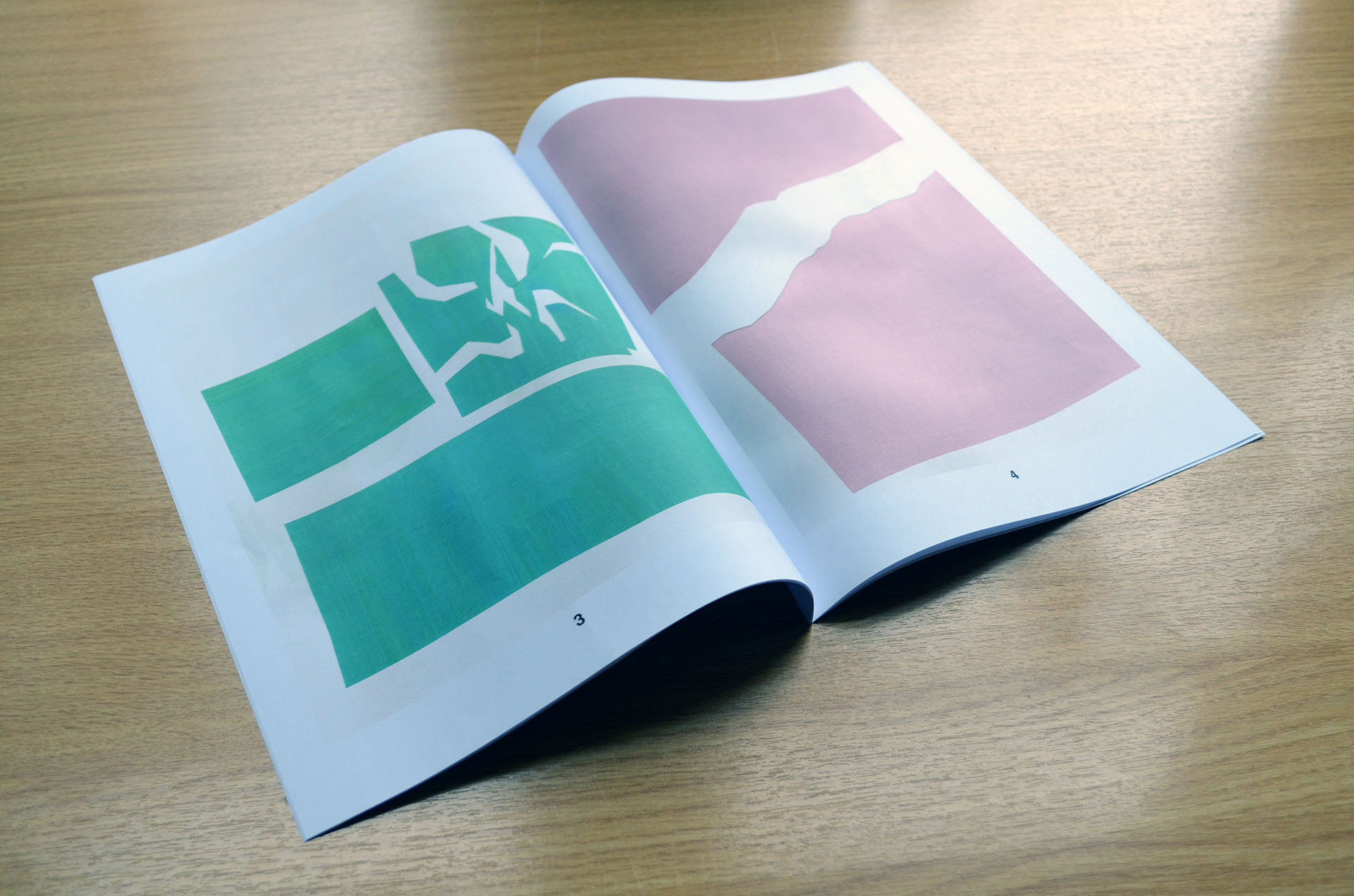 Open spread of booklet showing minimal coloured collages