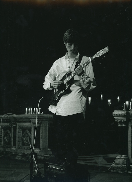 Gabriel playing guitar in cathedral 