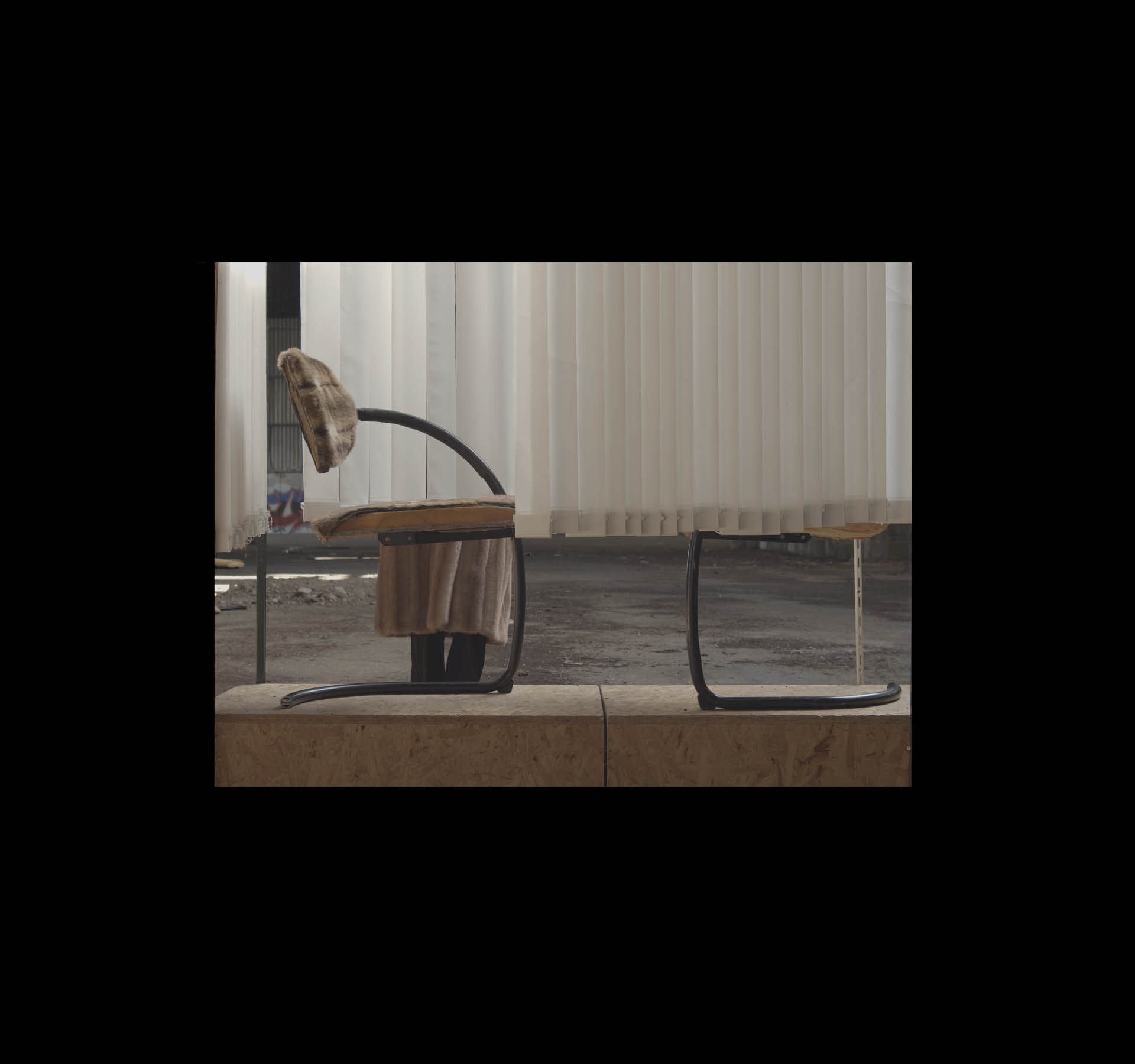 L'usine MF. Still of a filmed scenography, France, April 2021. Vertical blinds, waiting room chair, fur, stage, fur coat, actor.
