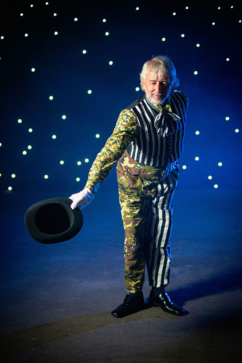 Prospero the Enchanter taking hat off to audience and bowing.