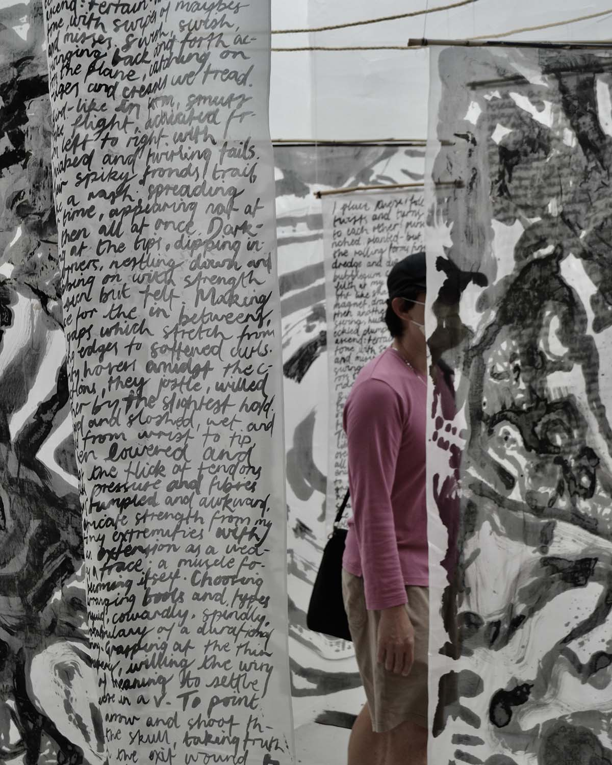 person walking through the silk hanging 