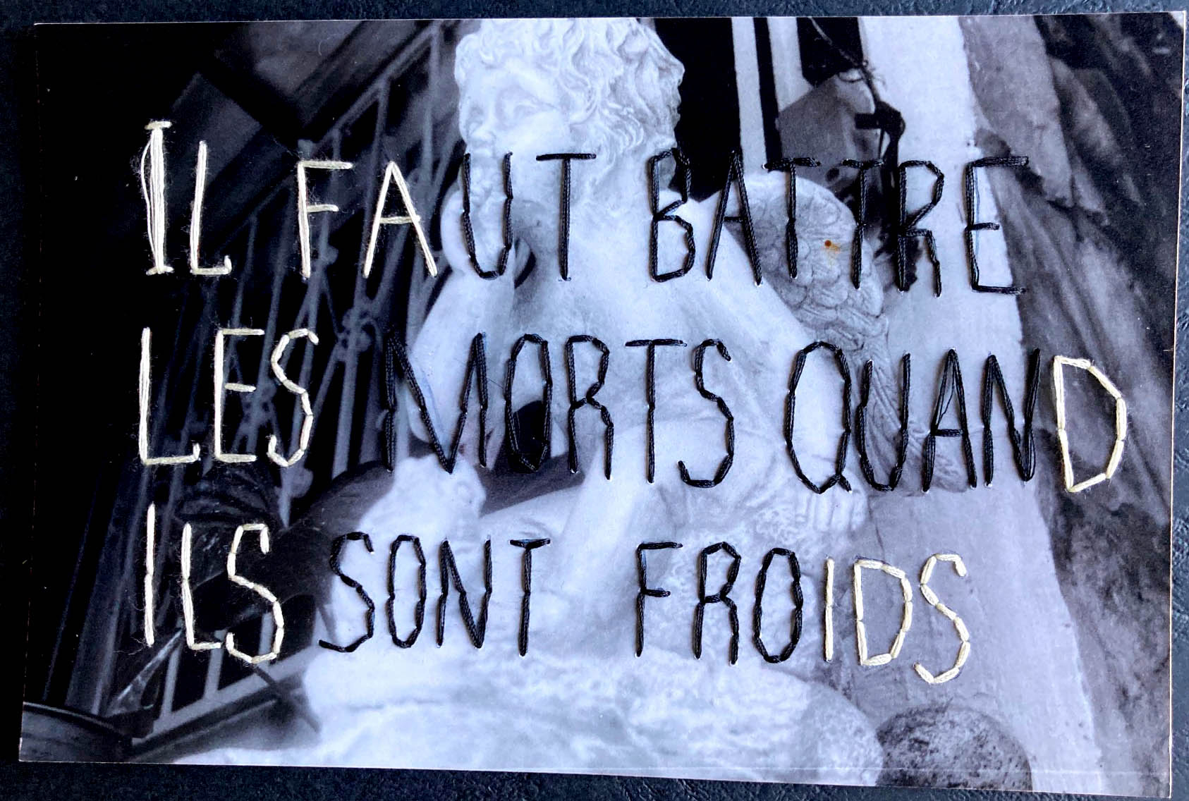 Embroidery illustration with a text in French which translates "You must beat the dead when they're cold"