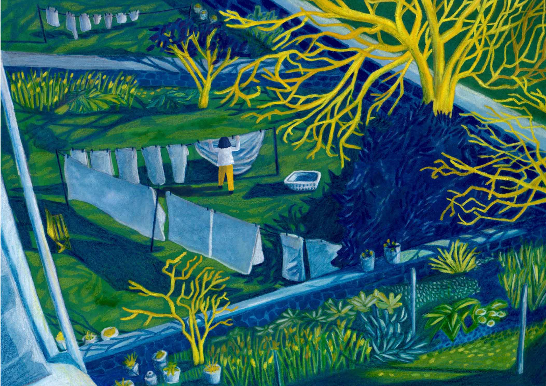 A woman hangs washing on a washing line in her garden. The grass is dark green and the trees are yellow. 