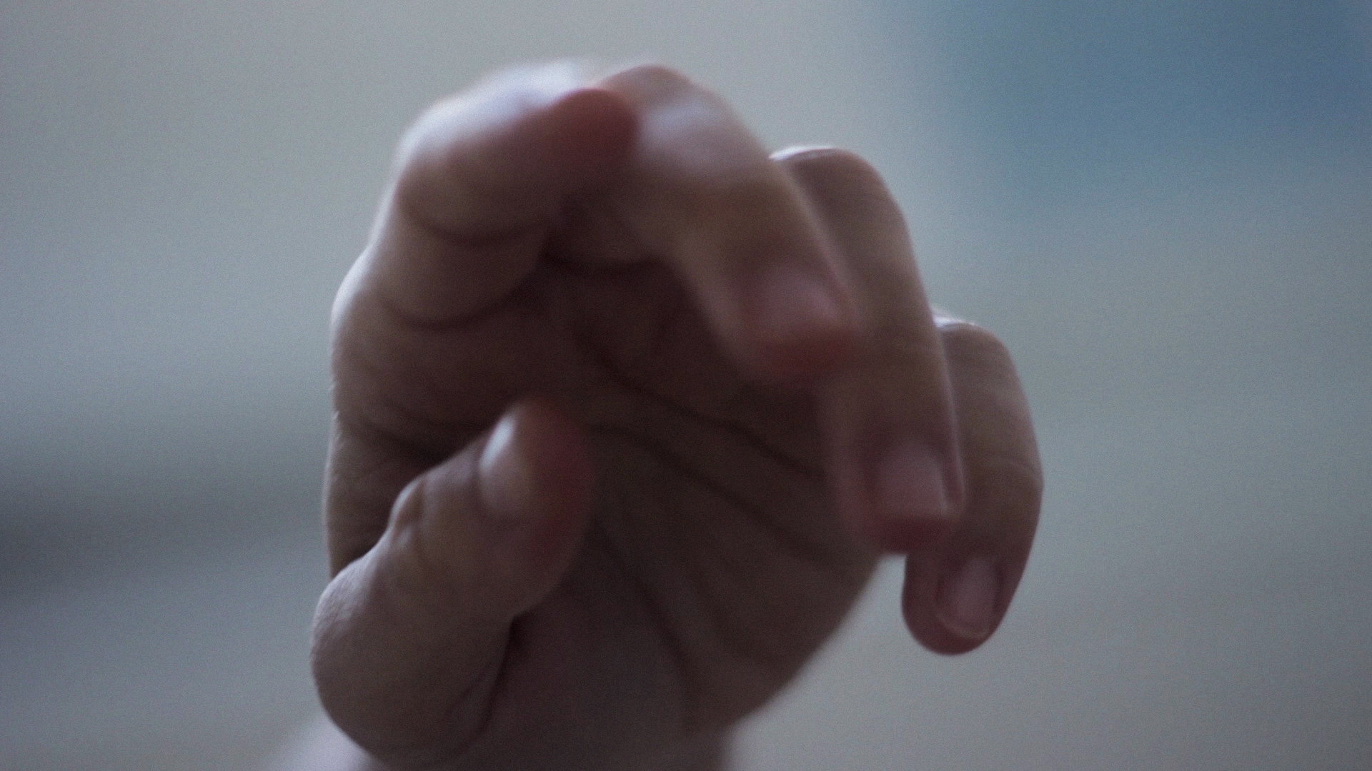 Close up of a hand reaching toward the camera