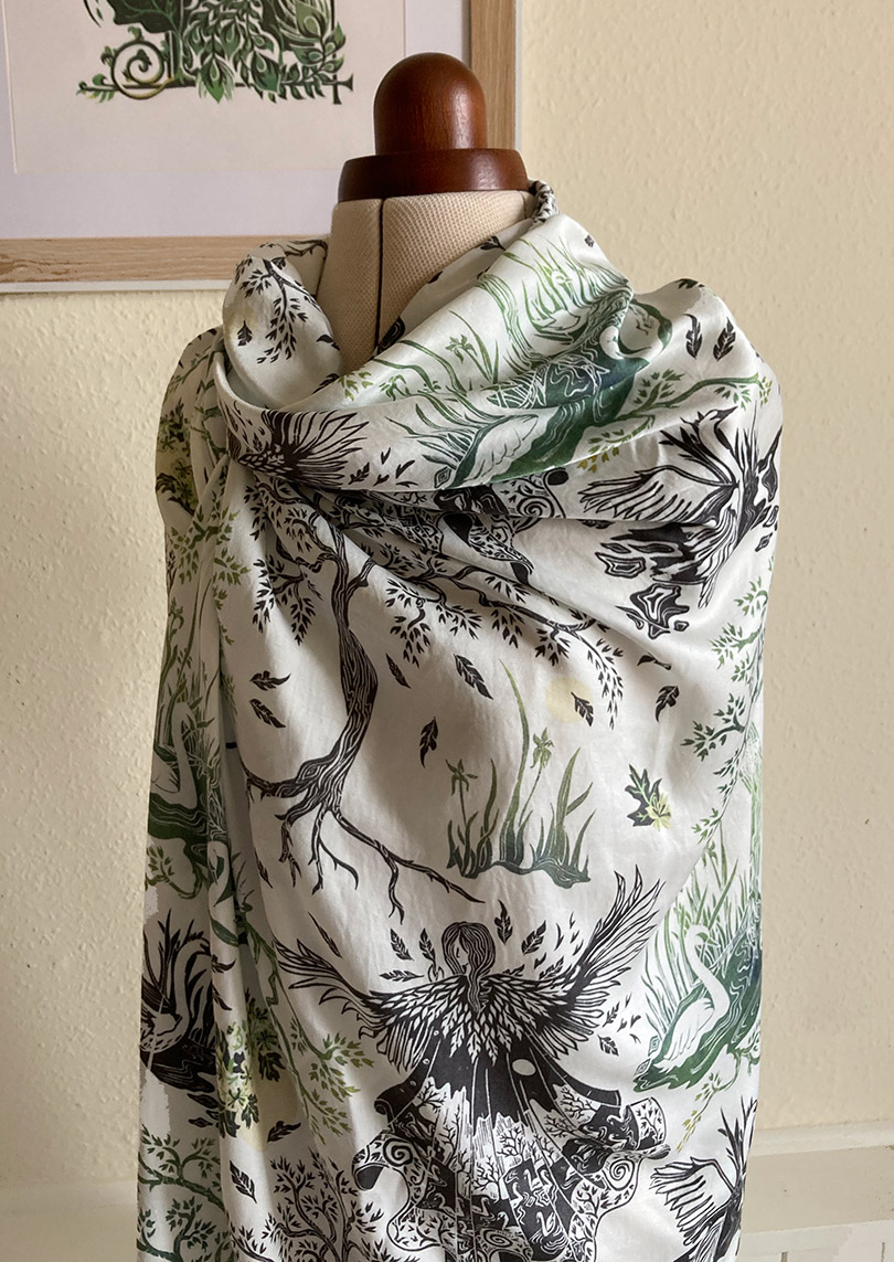 Photo of patterned fabric draped over a mannequin with corner of frame in the background.