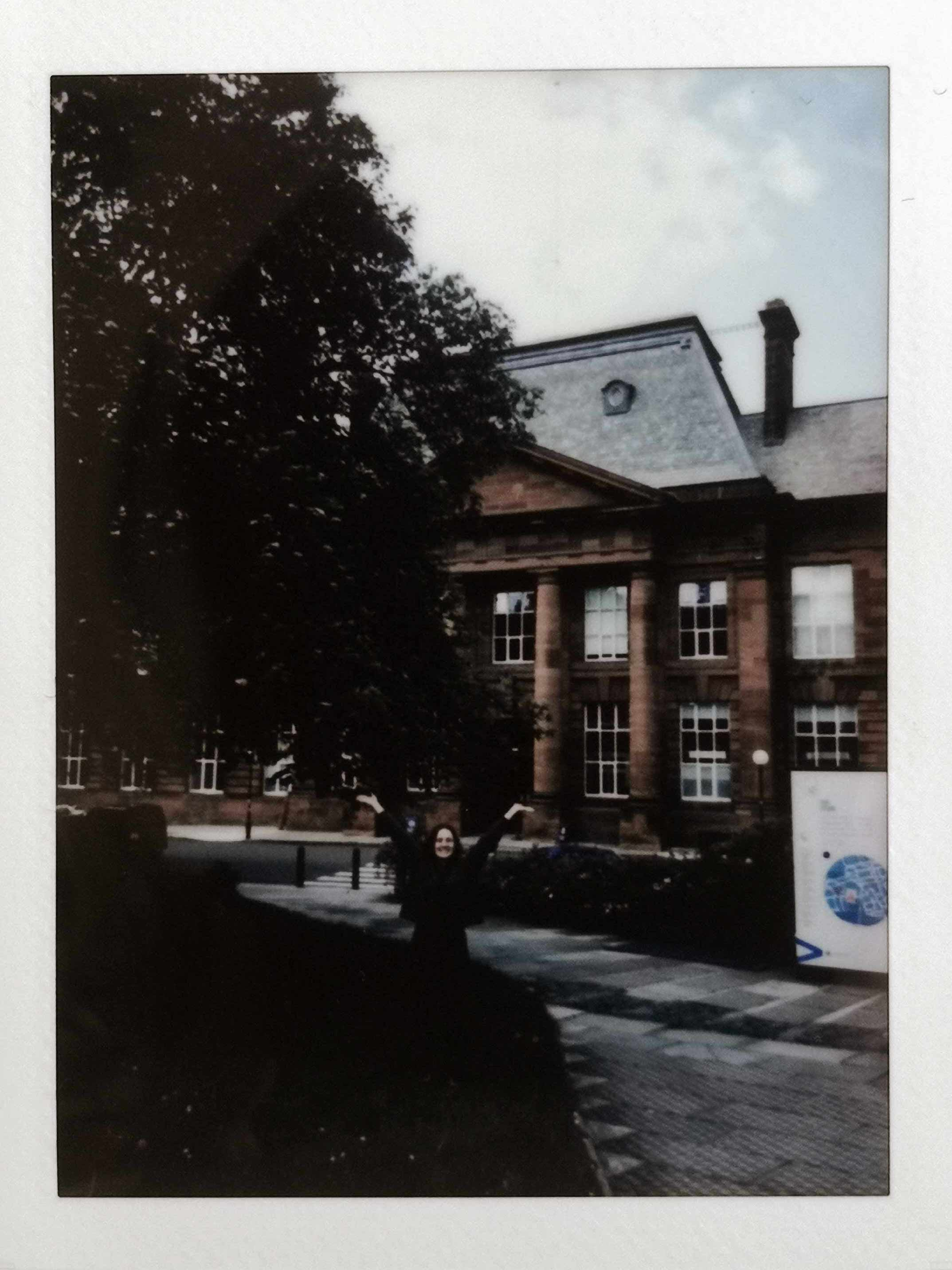 Polaroid of the student posing in front of ECA.