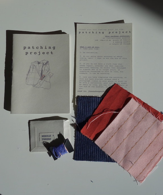A photo of an a6 booklet, a thread and needle, three pieces of fabric