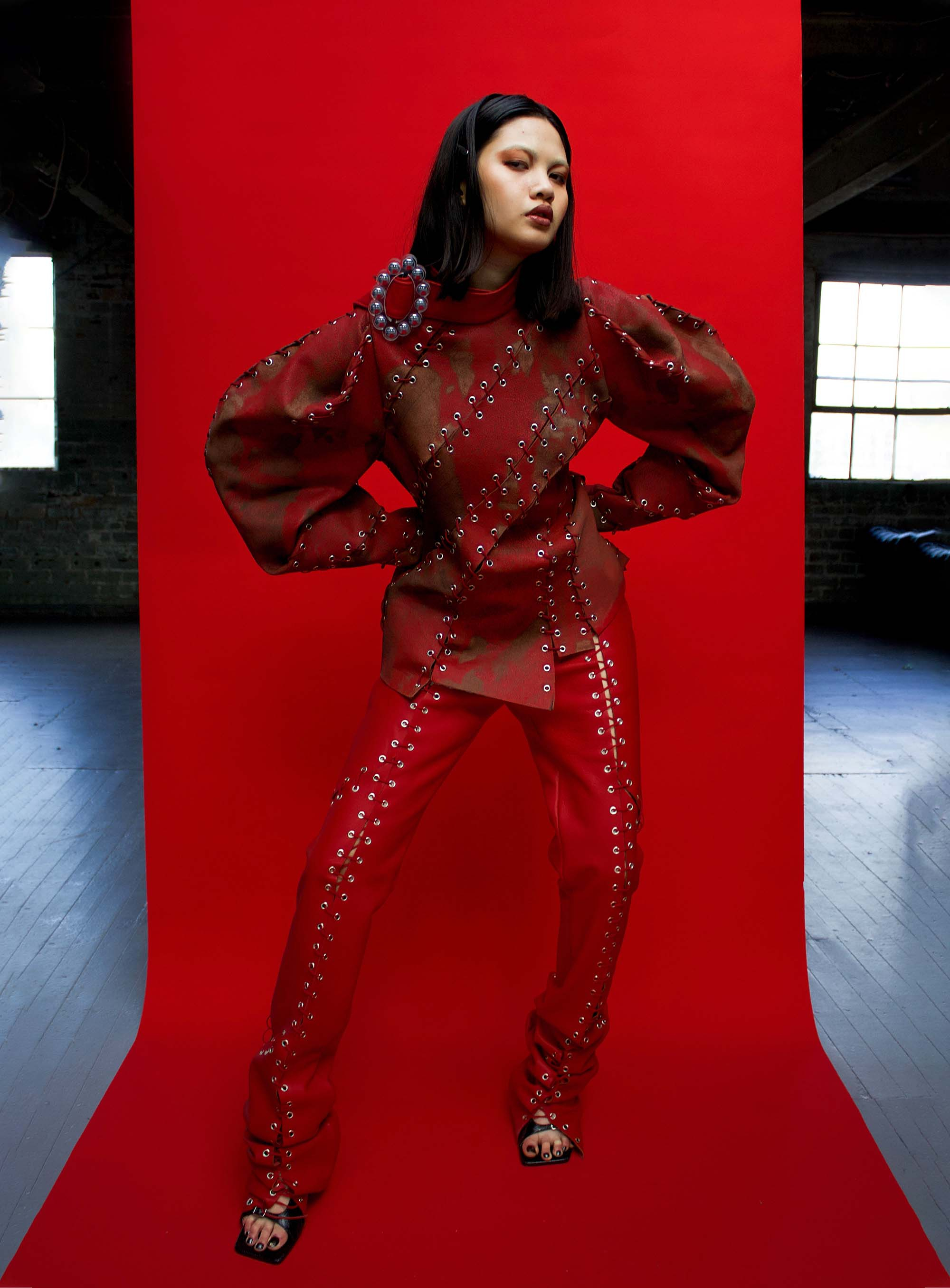 Model wears red laser-etched leather suit