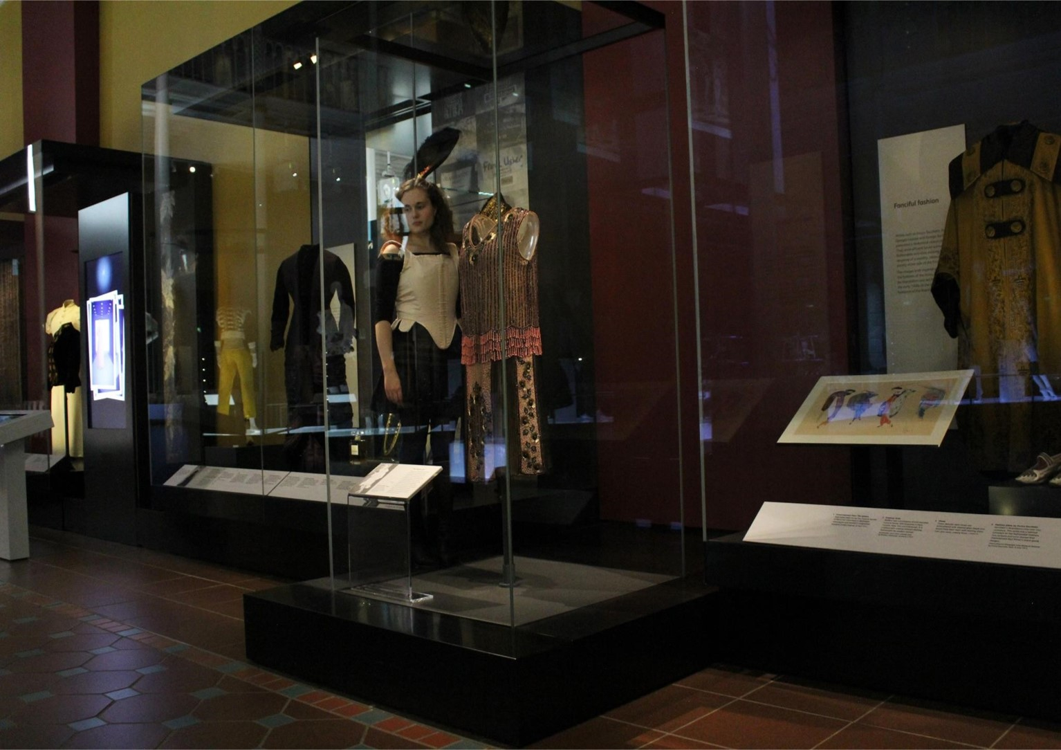 A person standing in a museum wearing a corset