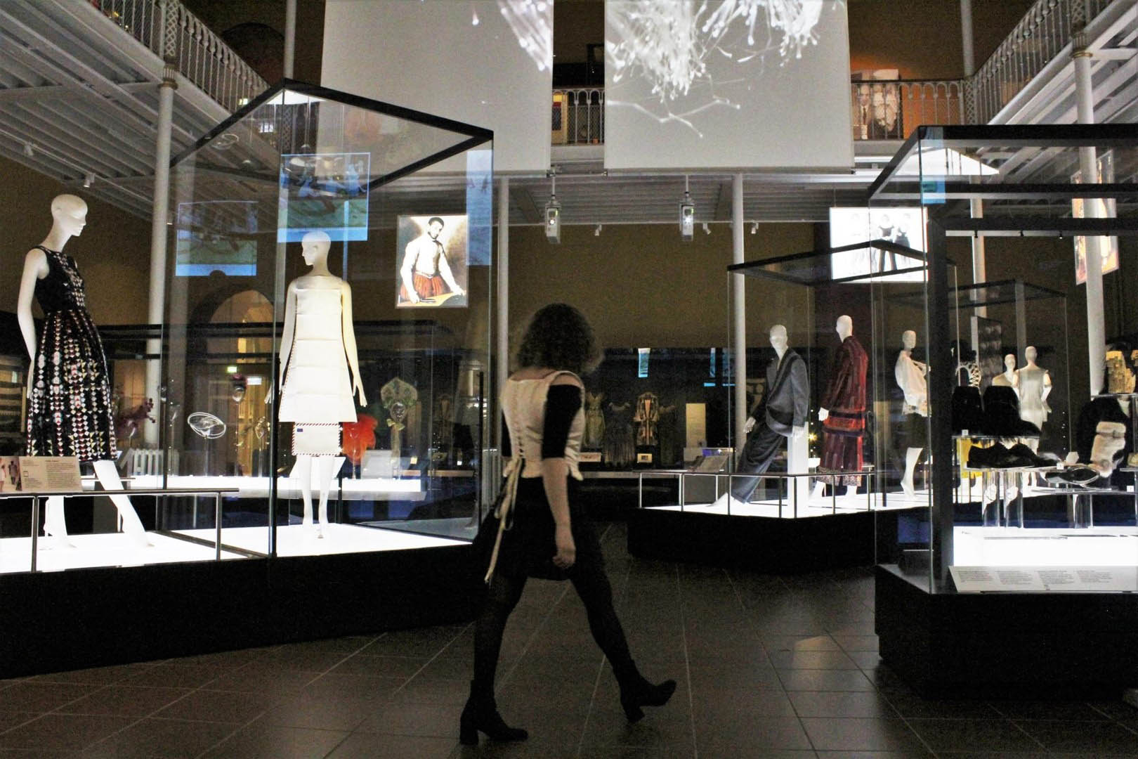A person standing in a museum wearing a corset