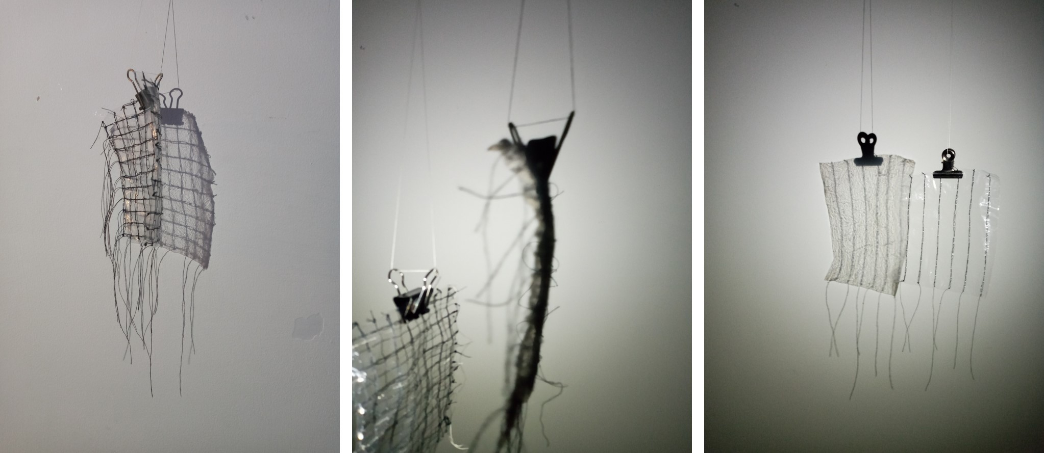 Small squares of clear plastic with thread sewn through them and shadows