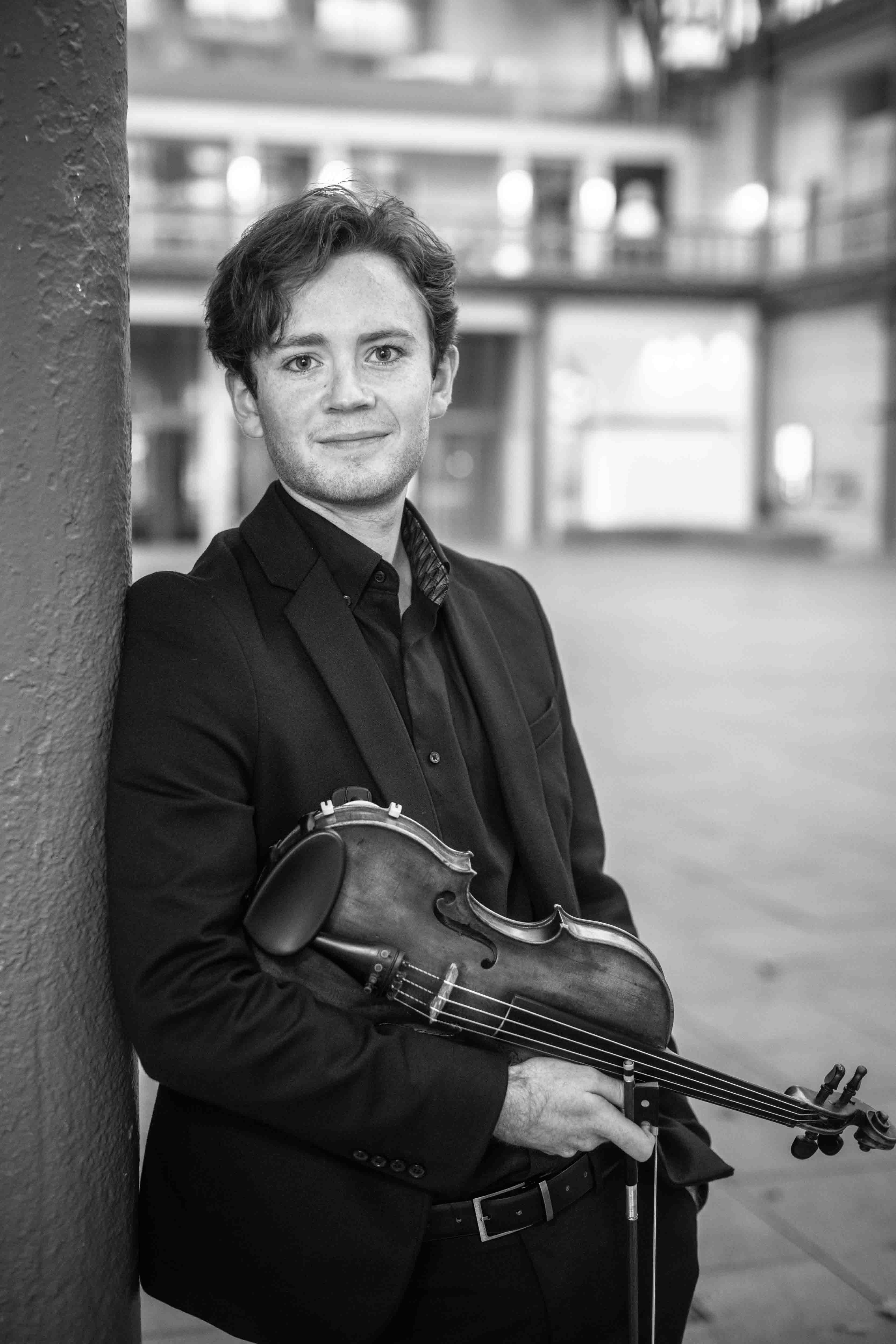 Andrew Taheny holding a violin